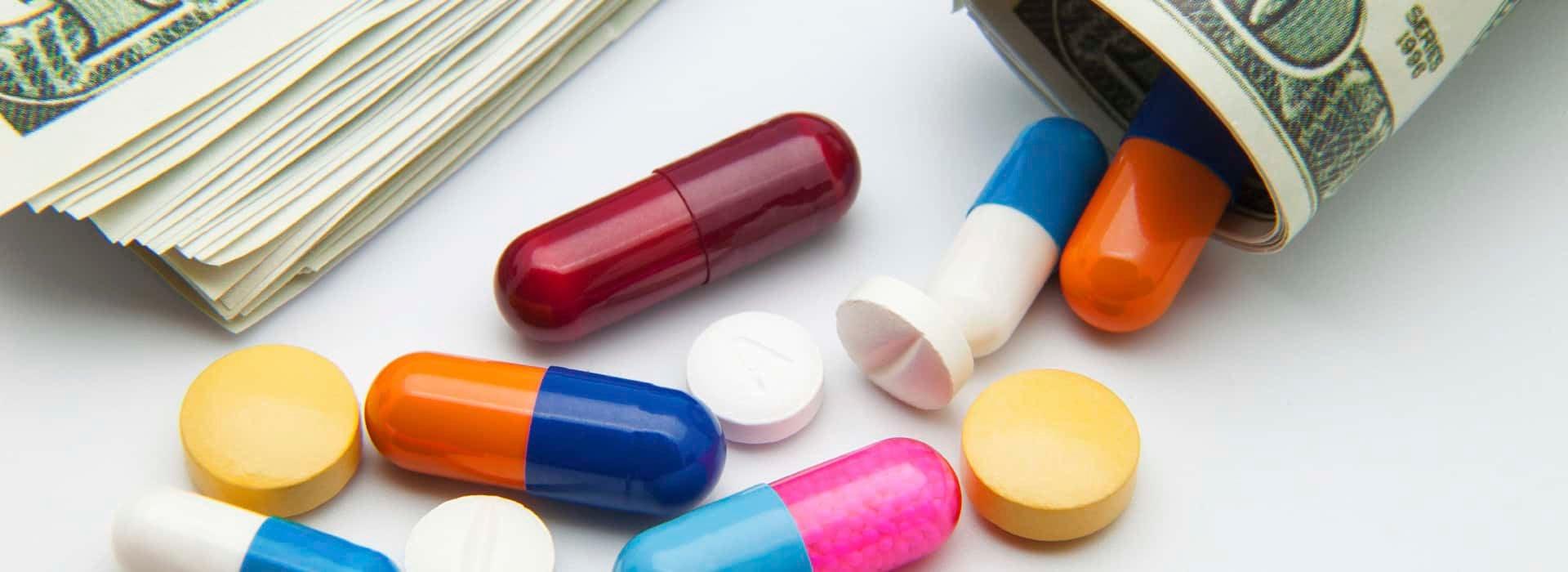 Prescription pills and rolls of dollar bills