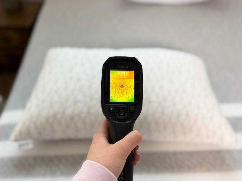 A thermal gun reads the heat signature of the Coop Sleep Adjustable Pillow