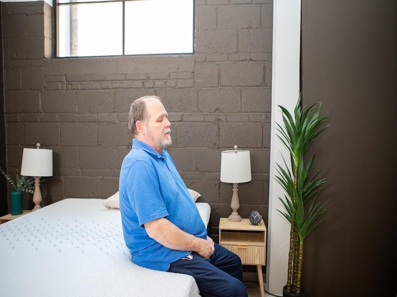 A man evaluating the Nectar Classic Memory Foam’s edge support