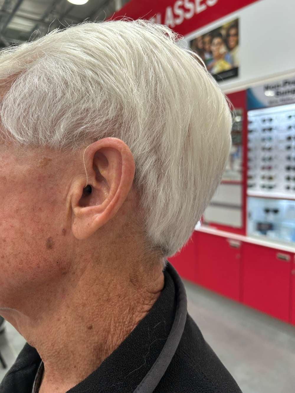 Jabra Enhance hearing aid in man's left ear