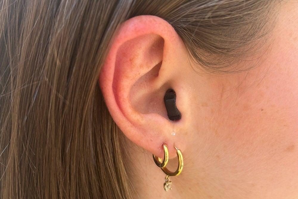 Audicus hearing aid in woman's right ear