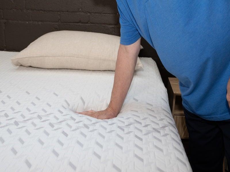 A man pressing on the Nectar Memory Foam mattress