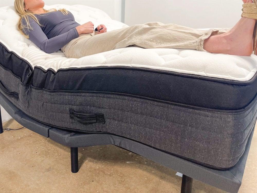 A woman lying on the Nolah Evolution mattress on an adjustable base