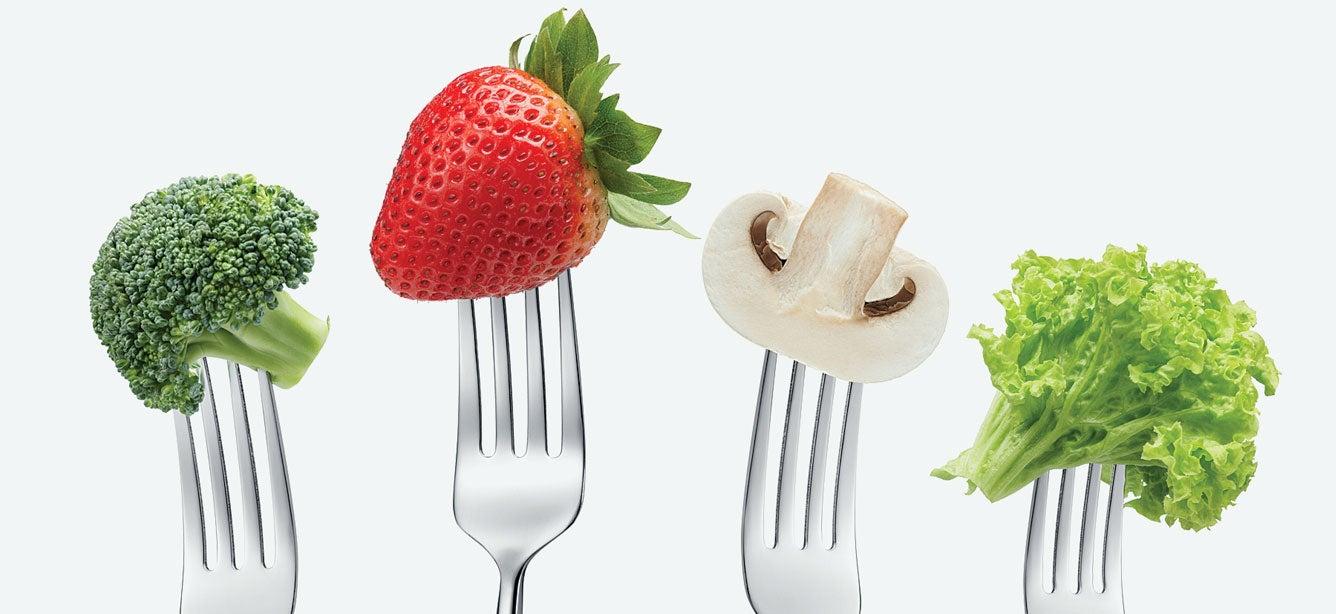 Four forks are pictures with various vegetables and fruit at their ends.