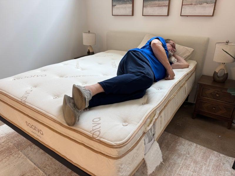 A man lying on his side on the Saatva Latex Hybrid mattress