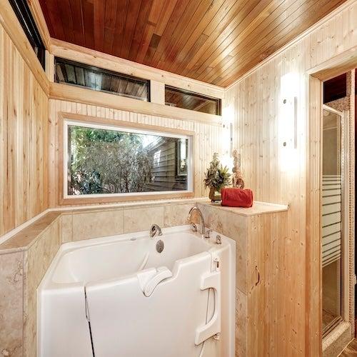 Walk-in tub in a wood-panelled room