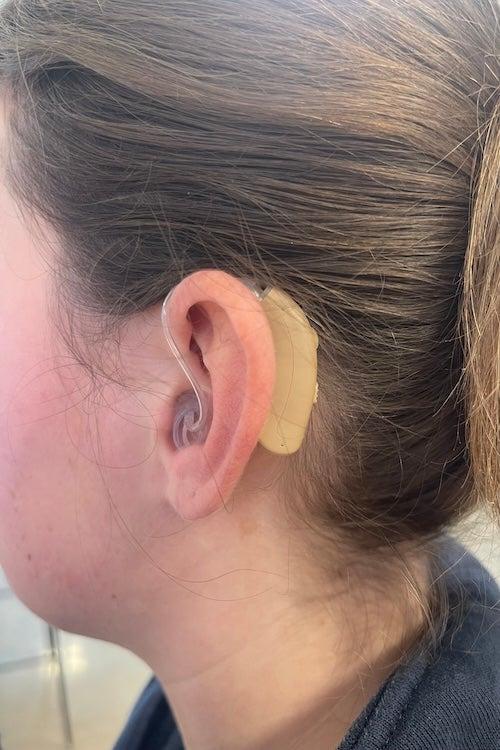 The MDHearing Volt hearing aid in a tester’s ear.