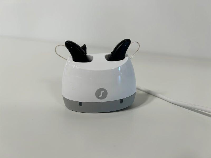 Signia hearing aids sitting in a charger