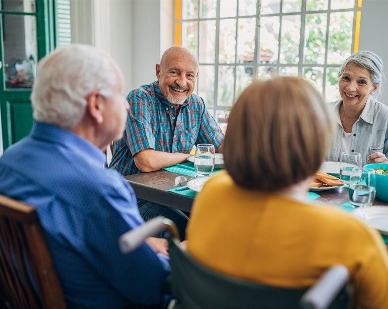 A group of older Americans are enjoying lunch at senior center.