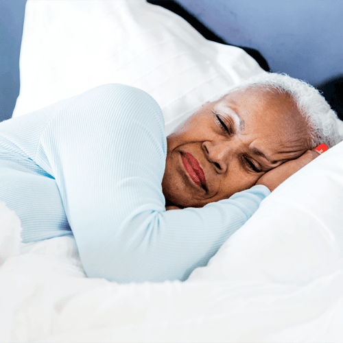 A woman lying in bed, asleep