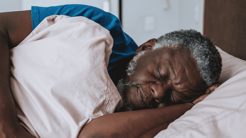 Man sleeping on his side in bed