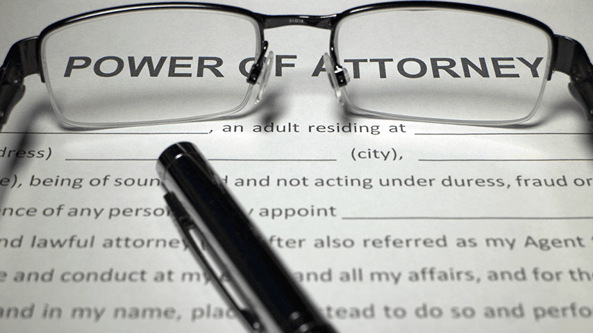 glasses and pen resting on a power of attorney document