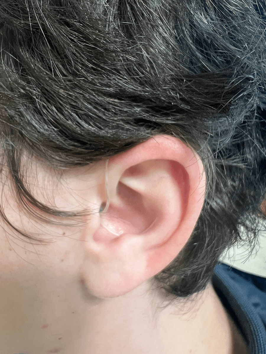 The Jabra Enhance hearing aids with sports lock in a man’s ear