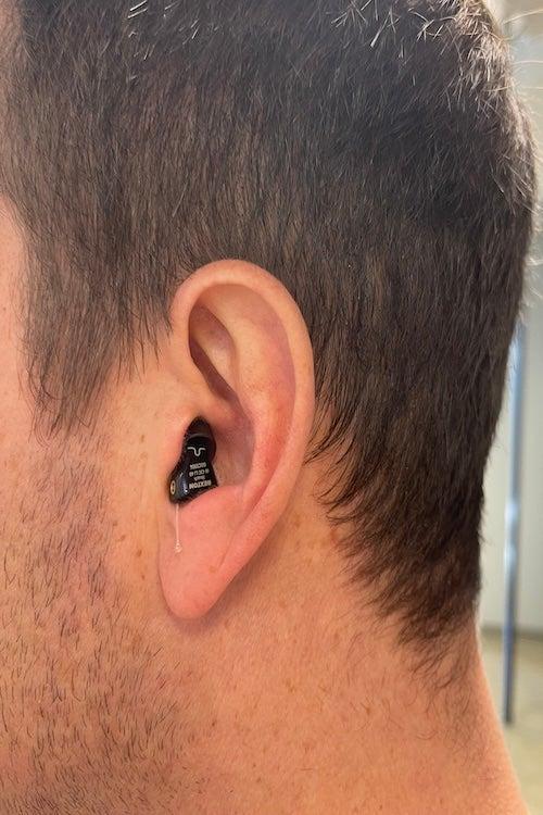 The Audicus Mini 2 in a male tester’s ear.