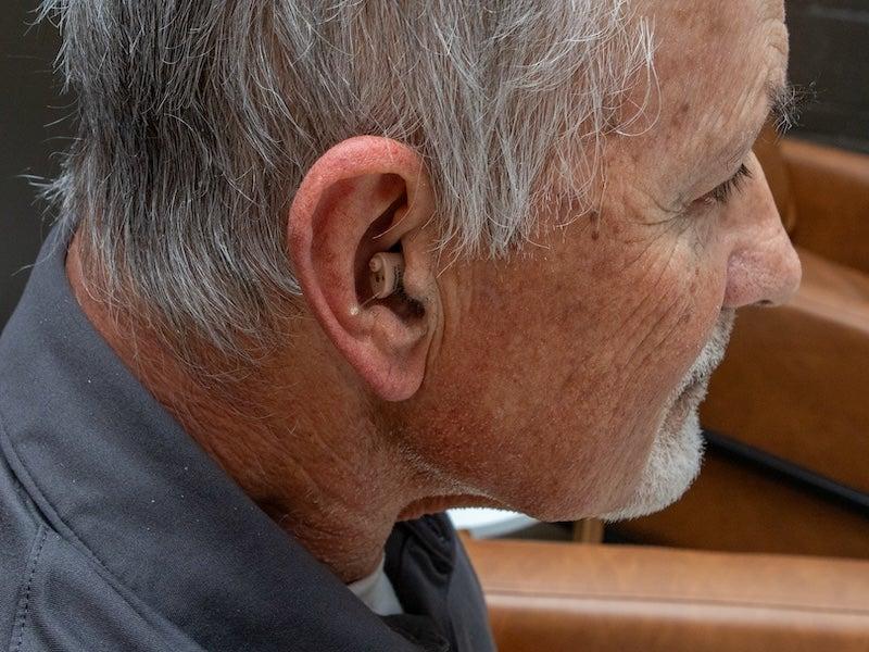 Man wearing the MDHearing Neo XS hearing aid.