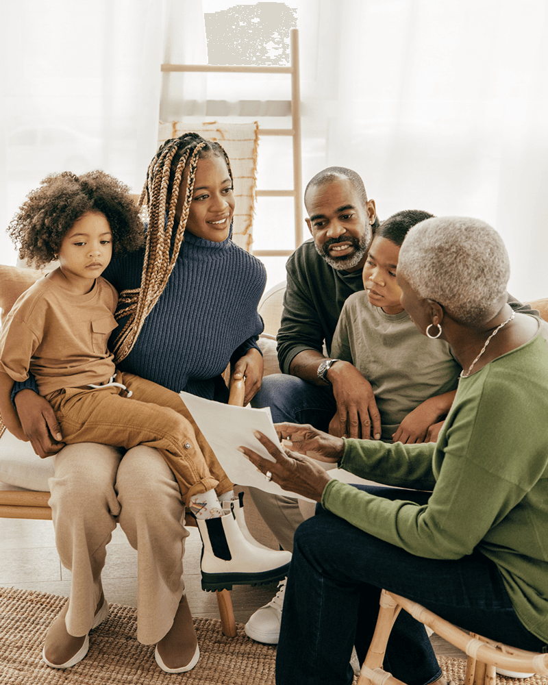 older mother and father going over paperwork with daughter and grandchildren
