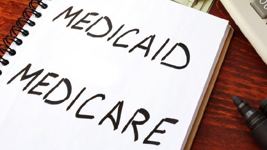 A notebook that has both 'Medicare' and 'Medicaid' written on it - as to indicate that someone could be dual eligible for both.