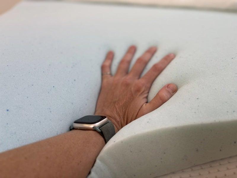 A hand pressing into the ViscoSoft Reflex Gel mattress topper