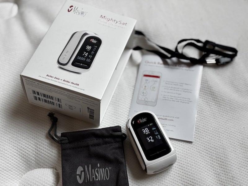 The MightySat pulse oximeter and its box, user manual, lanyard and carrying bag