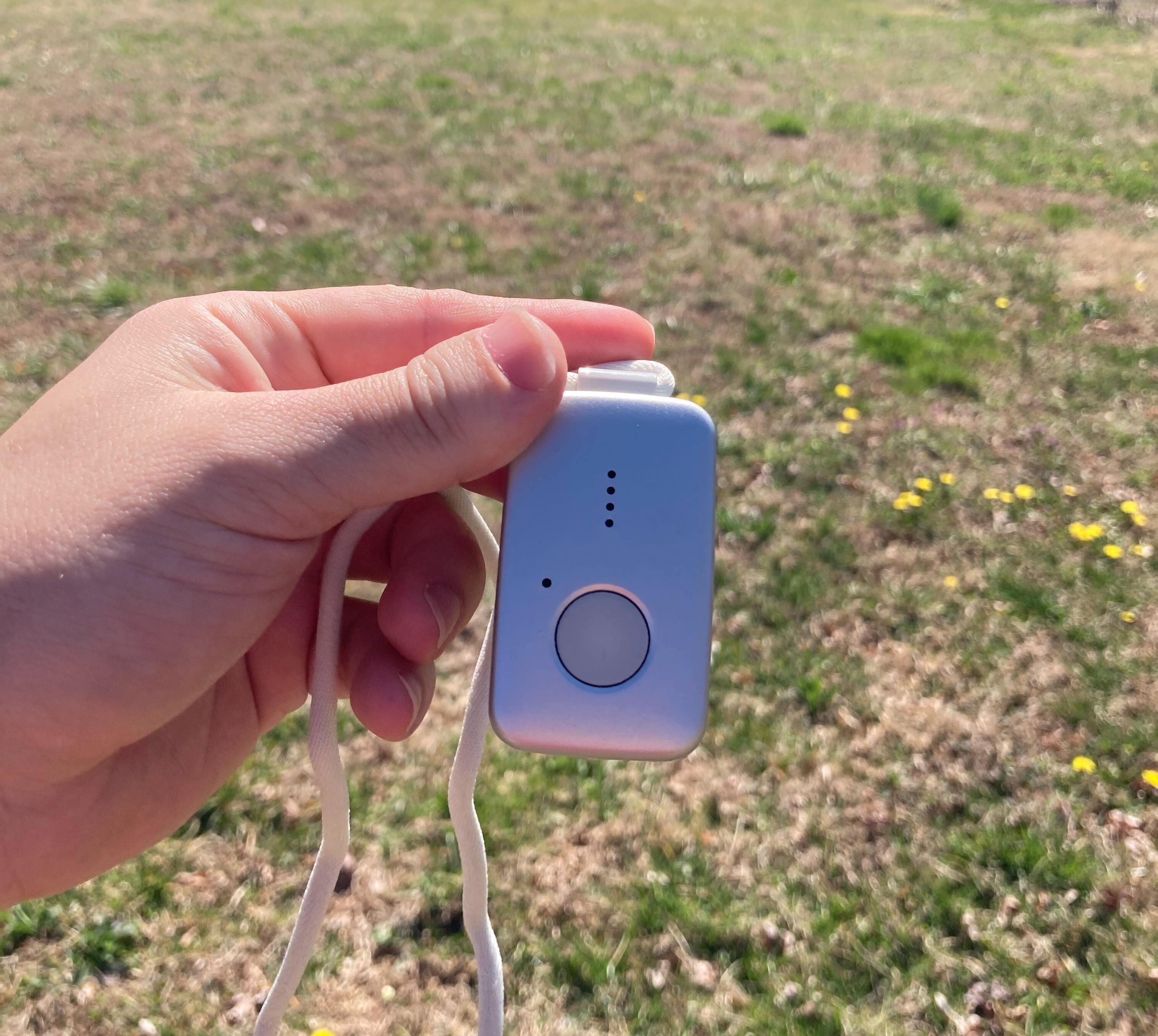 hand holding medical alert pendant