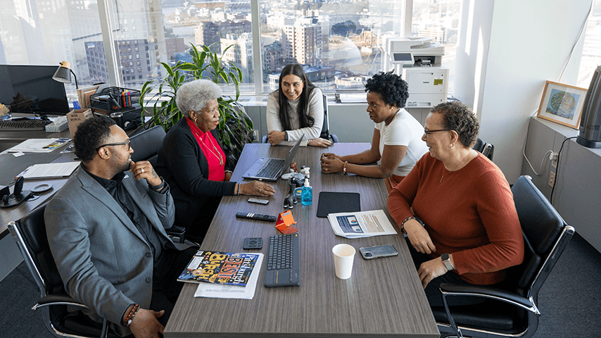 multigenerational workers gathered around a conference table