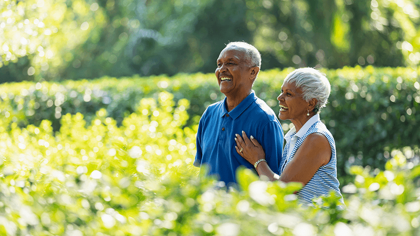 smiling older man and woman walking outside