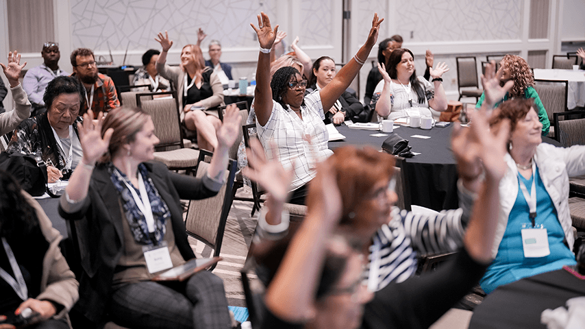 Audience at Age+Action senior center session with arms in the air