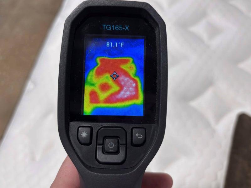 A heat gun pointed at the Nolah Evolution Comfort+ showing a temperature of 81.1 degrees