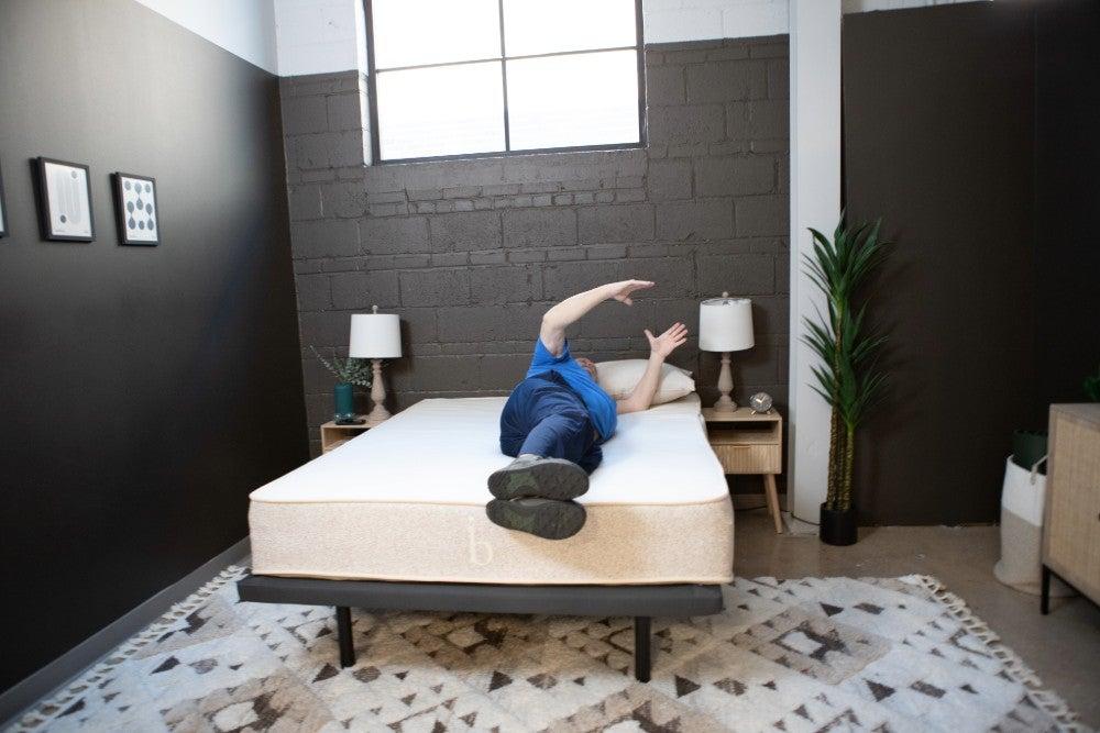 A man lying on his side on the Birch Natural mattress