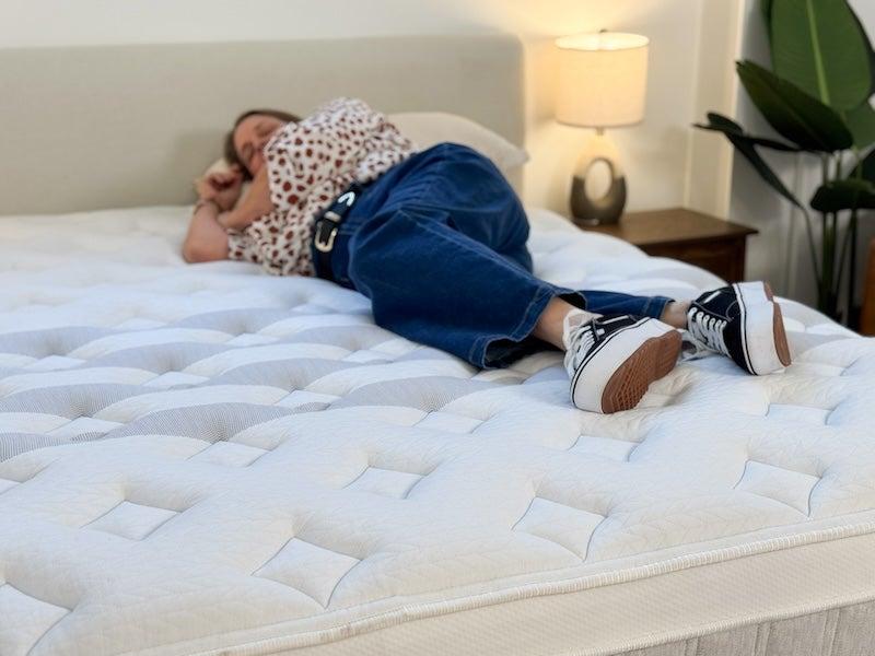 A woman lies on her side on the Leesa Sapira Chill mattress