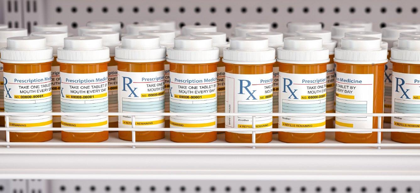 prescription pill bottles lined up on a shelf