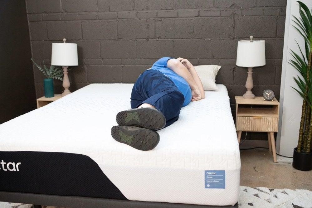A man lying on his side on the Nectar Memory Foam mattress