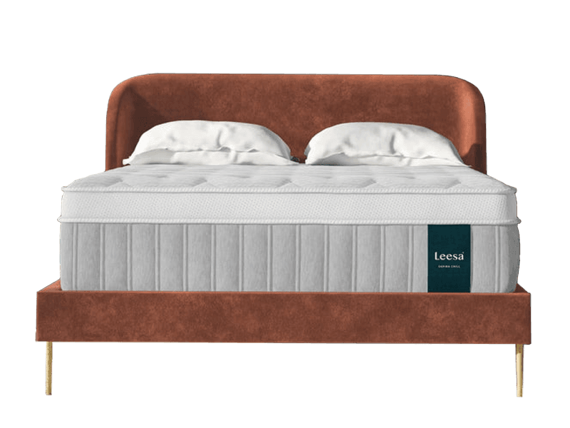 The Leesa Sapira Chill mattress with pillows and a brown headboard