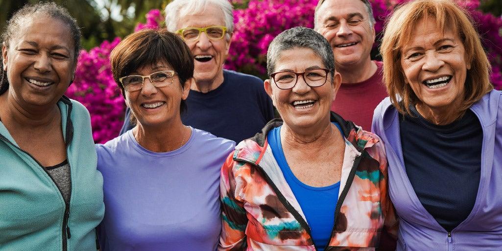 six smiling older adults