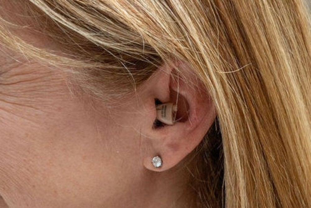 MDHearing hearing aid in woman's left ear