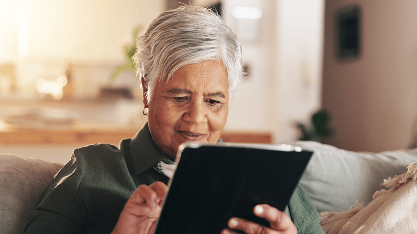 older black woman using computer tablet