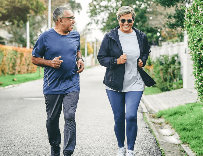 smiling man and woman on a power walk