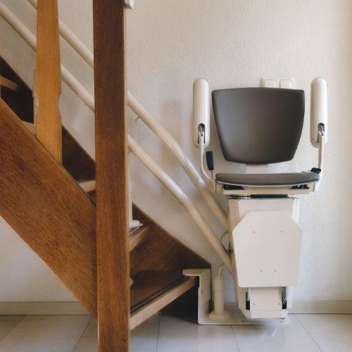 Automatic stair lift on staircase in a house